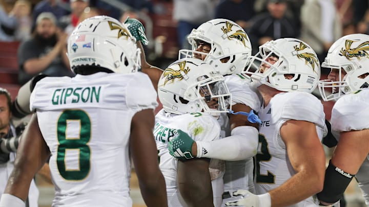 Sep 16, 2023; Stanford, California, USA; Sacramento State Hornets running back Marcus Fulcher (9) is congratulated by teammates after scoring a touchdown during the fourth quarter against the Stanford Cardinal at Stanford Stadium. Mandatory Credit: Sergio Estrada-Imagn Images