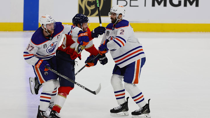 Edmonton Oilers forward Connor McDavid (97) and defenseman Evan Bouchard (2) defend against Florida Panthers defenseman Josh Mahura (28)