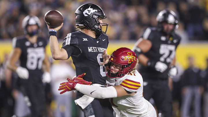 Oct 12, 2024; Morgantown, West Virginia, USA; Iowa State Cyclones linebacker Rylan Barnes (41) pressures West Virginia Mountaineers quarterback Garrett Greene (6) during a pass during the second quarter at Mountaineer Field at Milan Puskar Stadium. Mandatory Credit: Ben Queen-Imagn Images