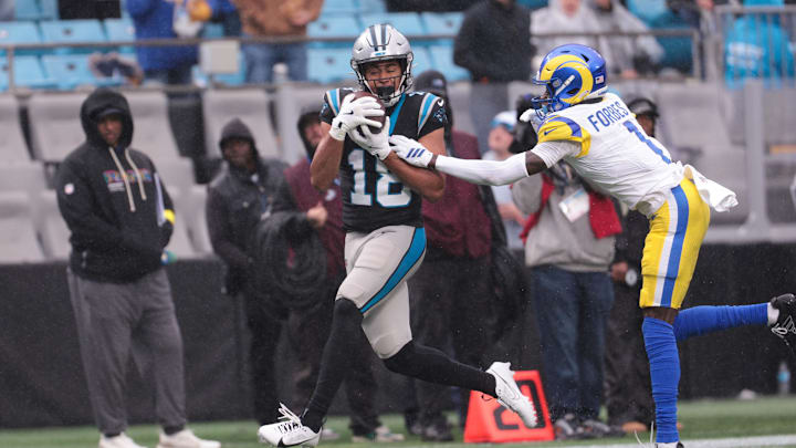 Nov 30, 2025; Charlotte, North Carolina, USA; Carolina Panthers wide receiver Jalen Coker (18) makes a catch as Los Angeles Rams cornerback Emmanuel Forbes Jr. (1) defends during the third quarter at Bank of America Stadium. Mandatory Credit: Scott Kinser-Imagn Images Nov 30, 2025; Charlotte, North Carolina, USA; Carolina Panthers wide receiver Jalen Coker (18) makes a catch as Los Angeles Rams cornerback Emmanuel Forbes Jr. (1) defends during the third quarter at Bank of America Stadium. Mandatory Credit: Scott Kinser-Imagn Images