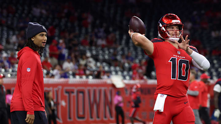 Nov 20, 2025; Houston, Texas, USA; Houston Texans quarterback C.J. Stroud (7) looks on as quarterback Davis Mills (10) warms up before the game against the Buffalo Bills at NRG Stadium. Mandatory Credit: Thomas Shea-Imagn Images