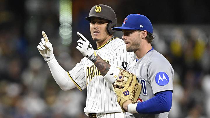 Apr 27, 2026; San Diego, California, USA; San Diego Padres third baseman Manny Machado (13) gestures after hitting a double as Chicago Cubs second baseman Nico Hoerner (2) looks on during the third inning at Petco Park. Mandatory Credit: Denis Poroy-Imagn Images