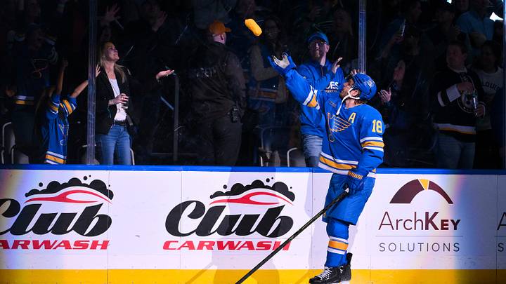 Mar 13, 2026; St. Louis, Missouri, USA; St. Louis Blues center Robert Thomas (18) tosses a t-shirt in to the crowd after he was named first star of the game after scoring a game winning goal in overtime against the Edmonton Oilers at Enterprise Center. Mandatory Credit: Jeff Curry-Imagn Images