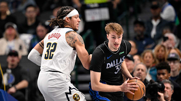 Jan 14, 2026; Dallas, Texas, USA; Dallas Mavericks forward Cooper Flagg (32) looks to move to the basket against Denver Nuggets forward Aaron Gordon (32) during the first quarter at the American Airlines Center. Mandatory Credit: Jerome Miron-Imagn Images