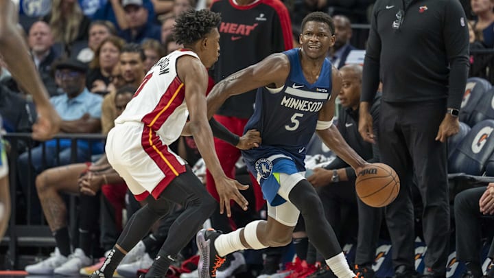 Nov 10, 2024; Minneapolis, Minnesota, USA; Minnesota Timberwolves guard Anthony Edwards (5) dribbles and looks to pass the ball as Miami Heat guard Josh Richardson (0) plays defense in second half at Target Center. Mandatory Credit: Jesse Johnson-Imagn Images