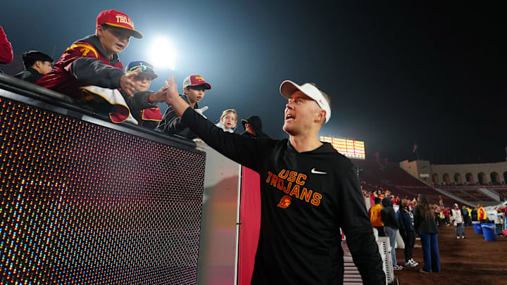 Nov 29, 2025; Los Angeles, California, USA; Southern California Trojans head coach Lincoln Riley celebrates with fans after the game against the UCLA Bruins at United Airlines Field at Los Angeles Memorial Coliseum. Mandatory Credit: Kirby Lee-Imagn Images Nov 29, 2025; Los Angeles, California, USA; Southern California Trojans head coach Lincoln Riley celebrates with fans after the game against the UCLA Bruins at United Airlines Field at Los Angeles Memorial Coliseum. Mandatory Credit: Kirby Lee-Imagn Images