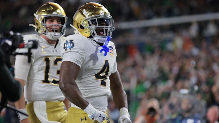 Jan 9, 2025; Miami, FL, USA; Notre Dame Fighting Irish running back Jeremiyah Love (4) celebrates a touch down in the second half against the Penn State Nittany Lions in the Orange Bowl at Hard Rock Stadium. Mandatory Credit: Sam Navarro-Imagn Images