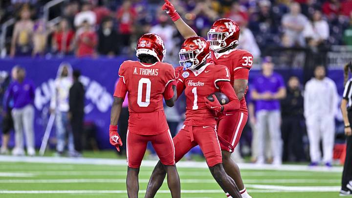 Dec 27, 2025; Houston, TX, USA; Houston Cougars defensive back Blake Thompson (0) and defensive back Latrell McCutchin Sr. (1) reacts during the second half against the Louisiana State Tigers at NRG Stadium. Mandatory Credit: Maria Lysaker-Imagn Images 