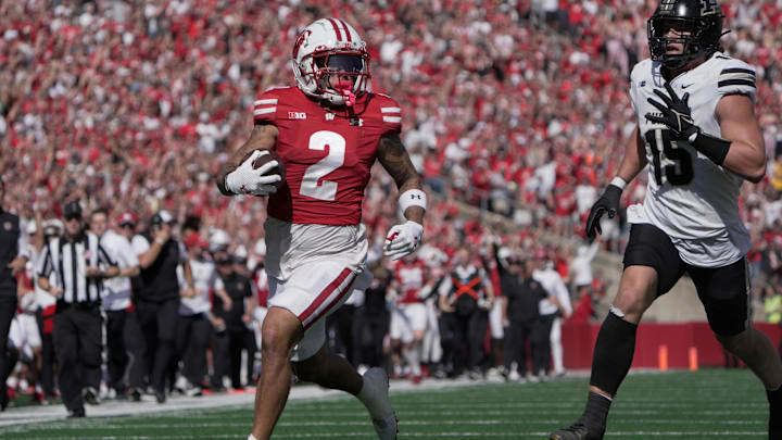 Wisconsin wide receiver Trech Kekahuna (2) scores a touchdown on a 69-yard reception as Purdue defensive back Botros Alisandro (19) looks on during the third quarter of their game Saturday, October 5, 2024 at Camp Randall Stadium in Madison, Wisconsin.