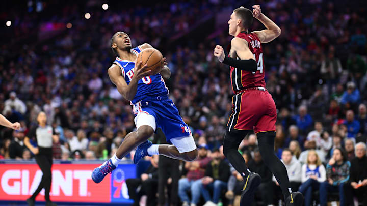 Feb 5, 2025; Philadelphia, Pennsylvania, USA; Philadelphia 76ers guard Tyrese Maxey (0) drives to shoot against Miami Heat guard Tyler Herro (14) in the third quarter at Wells Fargo Center. Mandatory Credit: Kyle Ross-Imagn Images