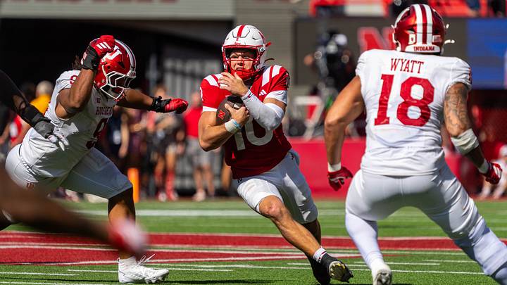 Oct 10, 2026; Lincoln, Nebraska, USA;  Nebraska Cornhuskers quarterback Anthony Colandrea (10) runs against Indiana Hoosiers defensive lineman Stephen Daley (9) and defensive lineman Kellan Wyatt (18) during the third quarterat Memorial Stadium.  Mandatory Credit: Dylan Widger-Imagn Images