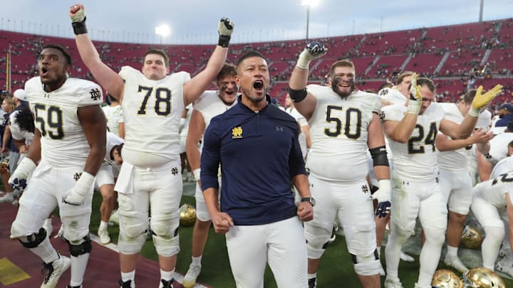 Nov 30, 2024; Los Angeles, California, USA; Notre Dame Fighting Irish head coach Marcus Freeman celebrates with players at the end of the game against the Southern California Trojans at United Airlines Field at Los Angeles Memorial Coliseum. Mandatory Credit: Kirby Lee-Imagn Images