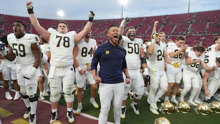Nov 30, 2024; Los Angeles, California, USA; Notre Dame Fighting Irish head coach Marcus Freeman celebrates with players at the end of the game against the Southern California Trojans at United Airlines Field at Los Angeles Memorial Coliseum. Mandatory Credit: Kirby Lee-Imagn Images