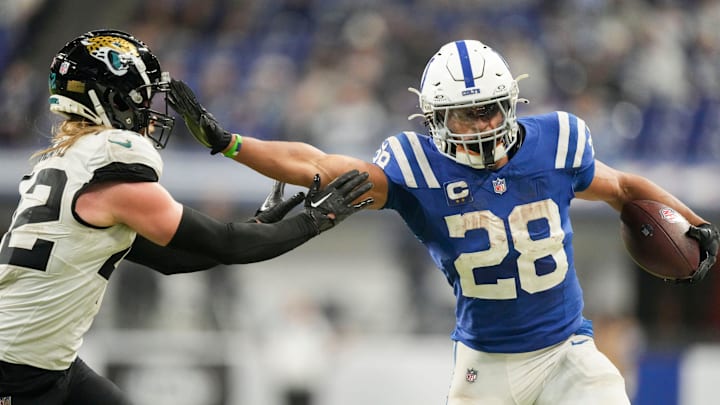 Indianapolis Colts running back Jonathan Taylor (28) pushes off Jacksonville Jaguars cornerback De'Antre Prince (24) as he rushes the ball Sunday, Jan. 5, 2025, during a game against the Jacksonville Jaguars at Lucas Oil Stadium in Indianapolis.