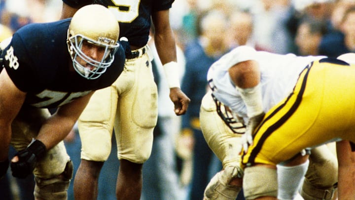 Jan 2, 1989; Tempe, AZ, USA; FILE PHOTO; Notre Dame Irish quarterback Tony Rice (9) and guard Tim Grunhard (75) on the field against the West Virginia Mountaineers during the 1989 National Championship Fiesta Bowl at Sun Devil Stadium. Notre Dame defeated West Virginia 34-21. Mandatory Credit: Malcolm Emmons-USA TODAY NETWORK