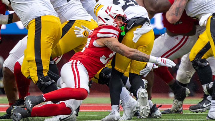 Nebraska defensive back Donovan Jones drives into Iowa running back Nathan McNeil.