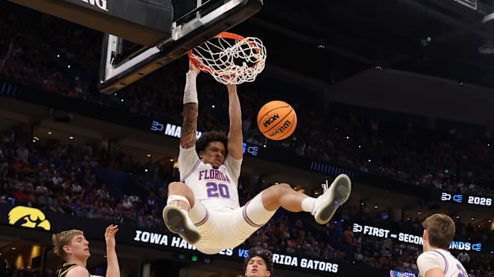 Mar 22, 2026; Tampa, FL, USA; Florida Gators guard Isaiah Brown (20) dunks the ball past Iowa Hawkeyes forward Cooper Koch (8) in the second half during a second round game of the men's 2026 NCAA Tournament at Benchmark International Arena. Mandatory Credit: Matt Pendleton-Imagn Images