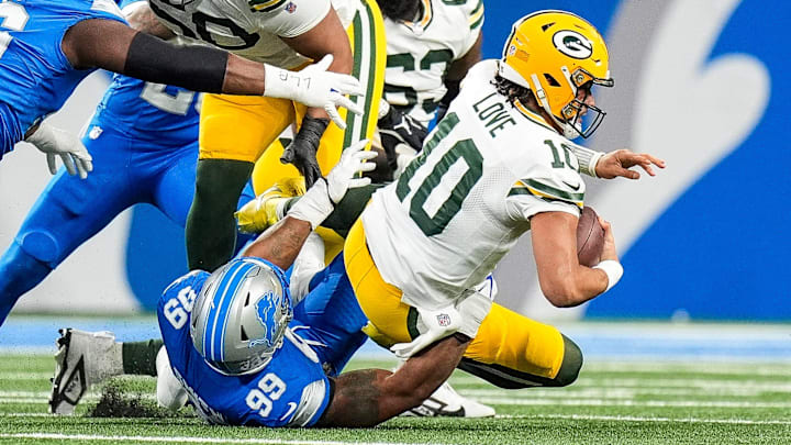 Detroit Lions defensive end Za'Darius Smith (99) sacks Green Bay Packers quarterback Jordan Love (10) during the first half at Ford Field in Detroit on Thursday, Dec. 5, 2024.