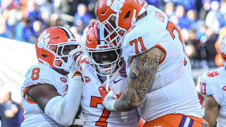 Clemson running back Phil Mafah (7) celebrates one of his four touchdowns against Kentucky with teammates wide receiver Adam Randall (8) and offensive lineman Tristan Leigh (71) during the fourth quarter of the TaxSlayer Gator Bowl at EverBank Stadium in Jacksonville, Florida, Friday, December 29, 2023. Clemson won 38-35.