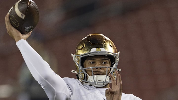 Nov 29, 2025; Stanford, California, USA;  Notre Dame Fighting Irish quarterback Kenny Minchey (8) warms up before the start of the first quarter against the Stanford Cardinal at Stanford Stadium. Mandatory Credit: Stan Szeto-Imagn Images