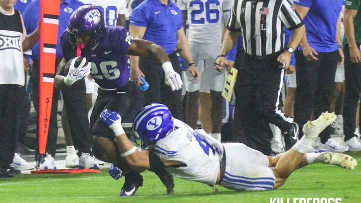 TCU running back Jeremy Payne (26) carries the ball near the sideline as a BYU defender dives toward him on Oct. 3, 2026, at Amon G. Carter Stadium.
