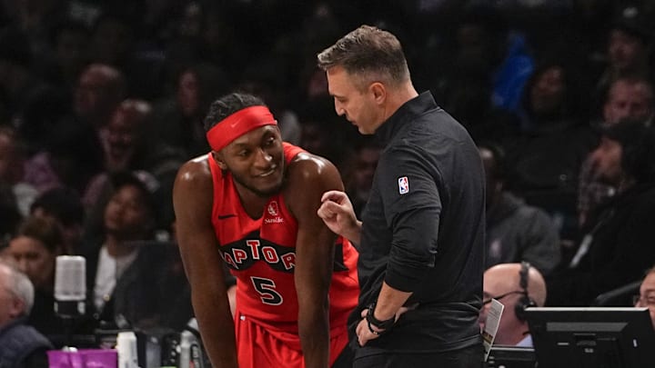 Oct 18, 2024; Brooklyn, New York, USA; Toronto Raptors head coach Darko Rajakovic speaks with Toronto Raptors shooting guard Immanuel Quickley (5) during the second half against the Brooklyn Nets at Barclays Center. Mandatory Credit: Gregory Fisher-Imagn Images