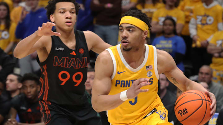 Feb 15, 2025; Pittsburgh, Pennsylvania, USA; Pittsburgh Panthers guard Ishmael Leggett (5) dribbles around Miami (Fl) Hurricanes guard Divine Ugochukwu (99) during the second half at the Petersen Events Center. Mandatory Credit: Charles LeClaire-Imagn Images