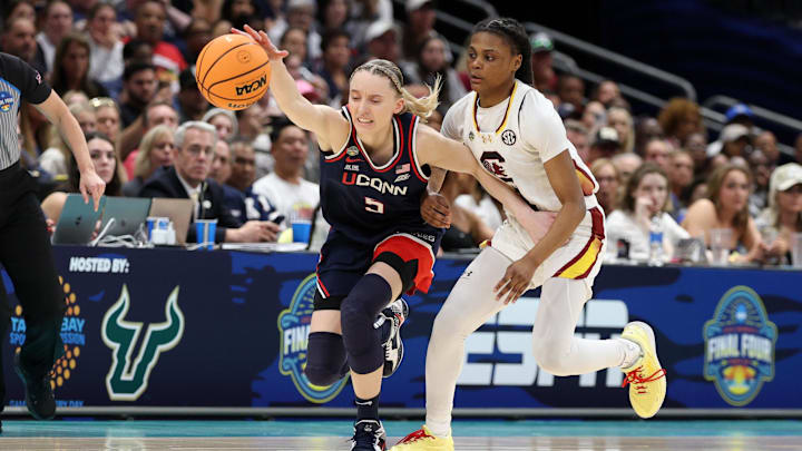 Apr 6, 2025; Tampa, FL, USA; Connecticut Huskies guard Paige Bueckers (5) and South Carolina Gamecocks guard MiLaysia Fulwiley (12) go after the ball during the second half of the national championship of the women's 2025 NCAA tournament at Amalie Arena. Mandatory Credit: Nathan Ray Seebeck-Imagn Images Apr 6, 2025; Tampa, FL, USA; Connecticut Huskies guard Paige Bueckers (5) and South Carolina Gamecocks guard MiLaysia Fulwiley (12) go after the ball during the second half of the national championship of the women's 2025 NCAA tournament at Amalie Arena. Mandatory Credit: Nathan Ray Seebeck-Imagn Images