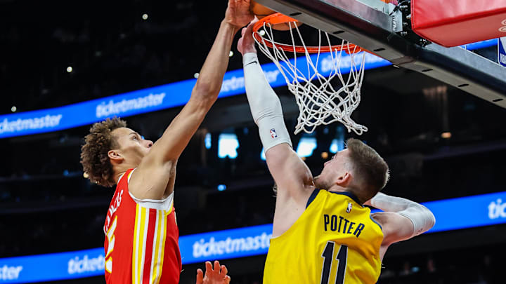 Jan 26, 2026; Atlanta, Georgia, USA; Atlanta Hawks guard Dyson Daniels (5) dunks the ball against Indiana Pacers center Micah Potter (11) during the first quarter at State Farm Arena. Mandatory Credit: Jordan Godfree-Imagn Images