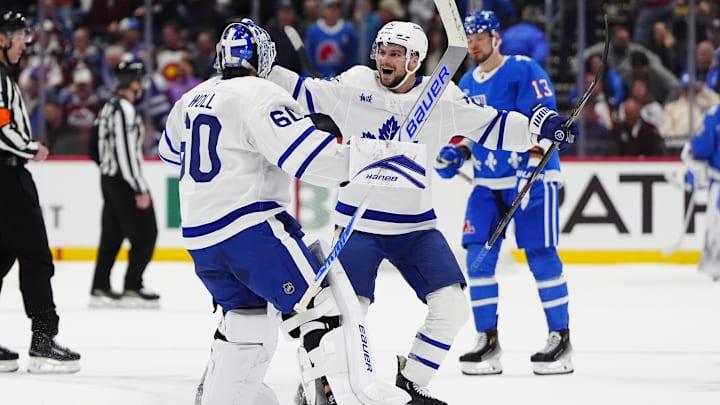 Jan 12, 2026; Denver, Colorado, USA; Toronto Maple Leafs goaltender Joseph Woll (60) and center Scott Laughton (24) celebrate defeating the Colorado Avalanche in overtime at Ball Arena. Mandatory Credit: Ron Chenoy-Imagn Images
