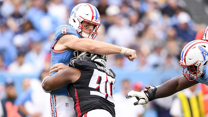 Oct 29, 2023; Nashville, Tennessee, USA;  Tennessee Titans quarterback Will Levis (8) throws a pass just before getting hit by Atlanta Falcons defensive tackle David Onyemata (90) during the second half at Nissan Stadium. Mandatory Credit: Steve Roberts-Imagn Images