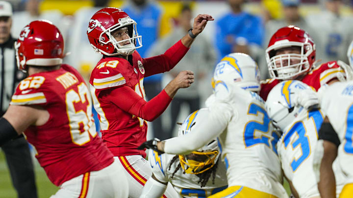 Dec 8, 2024; Kansas City, Missouri, USA; Kansas City Chiefs place kicker Matthew Wright (49) kicks a game winning field goal as time expires against the Los Angeles Chargers at GEHA Field at Arrowhead Stadium. Mandatory Credit: Jay Biggerstaff-Imagn Images