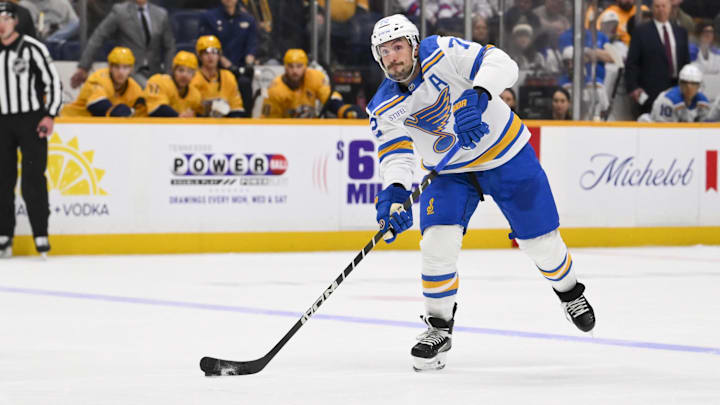 Feb 2, 2026; Nashville, Tennessee, USA;  St. Louis Blues defenseman Justin Faulk (72) takes a shot on goal against the Nashville Predators during the third period at Bridgestone Arena. Mandatory Credit: Steve Roberts-Imagn Images
