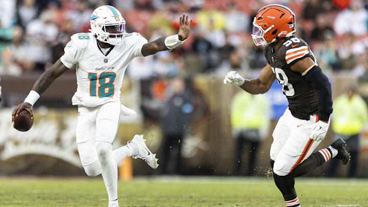 Miami Dolphins quarterback Tyler Huntley (18) is defended by Cleveland Browns linebacker Jordan Hicks (58) during the second quarter at Huntington Bank Field.