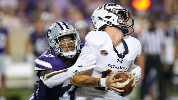 Aug 31, 2024; Manhattan, Kansas, USA; Tennessee-Martin Skyhawks quarterback Kaiya Sheron (12) is sacked by Kansas State Wildcats linebacker Kam Sallis (7) during the fourth quarter at Bill Snyder Family Football Stadium. Mandatory Credit: Scott Sewell-Imagn Images