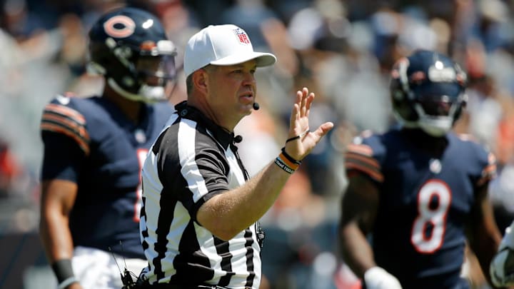 Aug 14, 2021; Chicago, Illinois, USA; Referee Brad Rogers (126) gestures during the first half of the game between the Chicago Bears and the Miami Dolphins at Soldier Field. Mandatory Credit: Jon Durr-Imagn Images