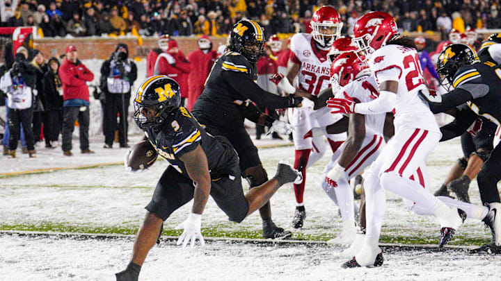 Nov 30, 2024; Columbia, Missouri, USA; Missouri Tigers running back Marcus Carroll (9) scores a touchdown against the Arkansas Razorbacks during the second half at Faurot Field at Memorial Stadium. Mandatory Credit: Denny Medley-Imagn Images