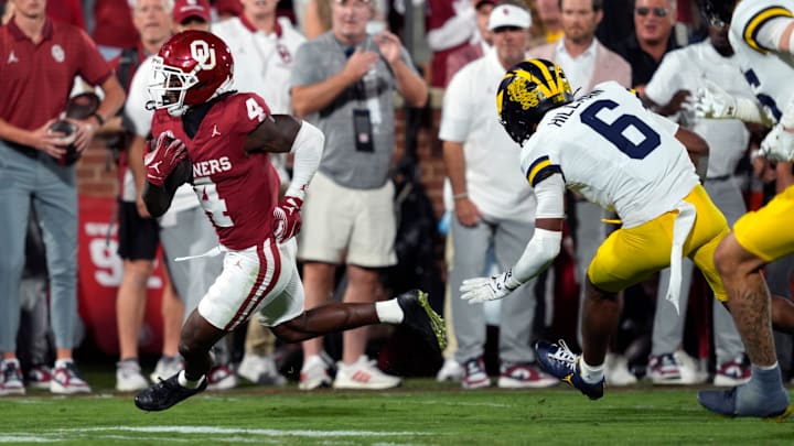 Oklahoma Sooners wide receiver Deion Burks (4) runs past Michigan Wolverines defensive back Brandyn Hillman (6) during a college football game between the University of Oklahoma Sooners (OU) and the University of Michigan Wolverines at Gaylord Family Ð Oklahoma Memorial Stadium in Norman, Okla., Saturday, Sept. 6, 2025.