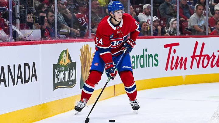 Sep 25, 2025; Montreal, Quebec, CAN; Montreal Canadiens defenseman David Reinbacher (64) considers his options with the puck against the Toronto Maple Leafs during the second period at Bell Centre. Mandatory Credit: David Kirouac-Imagn Images