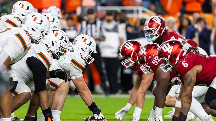 Jan 19, 2026; Miami Gardens, FL, USA; General view down the line of scrimmage as Miami Hurricanes offensive lineman James Brockermeyer (52) prepares to snap the ball against the Indiana Hoosiers during the College Football Playoff National Championship game at Hard Rock Stadium. Mandatory Credit: Mark J. Rebilas-Imagn Images