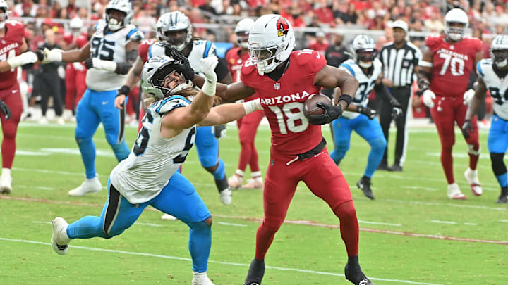 Sep 14, 2025; Glendale, Arizona, USA;  Arizona Cardinals wide receiver Marvin Harrison Jr. (18) runs the ball defended by Carolina Panthers linebacker Christian Rozeboom (56) during the third quarter at State Farm Stadium. Mandatory Credit: Matt Kartozian-Imagn Images