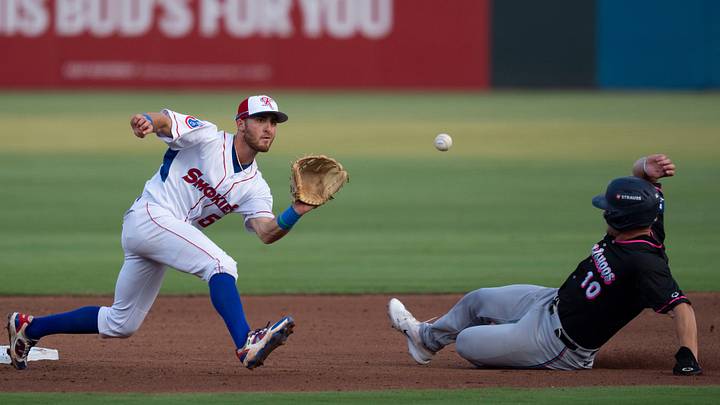 Brandon Compton (right) slides into second base