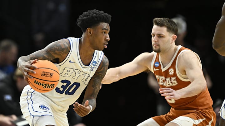 Mar 19, 2026; Portland, OR, USA; BYU Cougars guard Kennard Davis Jr. (30) dribbles against Texas Longhorns forward Camden Heide (5) in the second half during a first round game of the men's 2026 NCAA Tournament at Moda Center. Mandatory Credit: Craig Strobeck-Imagn Images