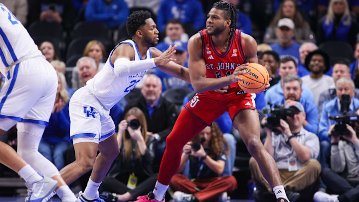 Dec 20, 2025; Atlanta, Georgia, USA; St. John Red Storm forward Zuby Ejiofor (24) is defended by Kentucky Wildcats forward Mouhamed Dioubate (23) in the first half at State Farm Arena. Mandatory Credit: Brett Davis-Imagn Images Dec 20, 2025; Atlanta, Georgia, USA; St. John Red Storm forward Zuby Ejiofor (24) is defended by Kentucky Wildcats forward Mouhamed Dioubate (23) in the first half at State Farm Arena. Mandatory Credit: Brett Davis-Imagn Images
