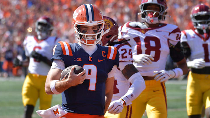 Sep 27, 2025; Champaign, Illinois, USA;  Illinois Fighting Illini quarterback Luke Altmyer (9) scores a touchdown during the first half against the Southern California Trojans at Memorial Stadium. Mandatory Credit: Ron Johnson-Imagn Images