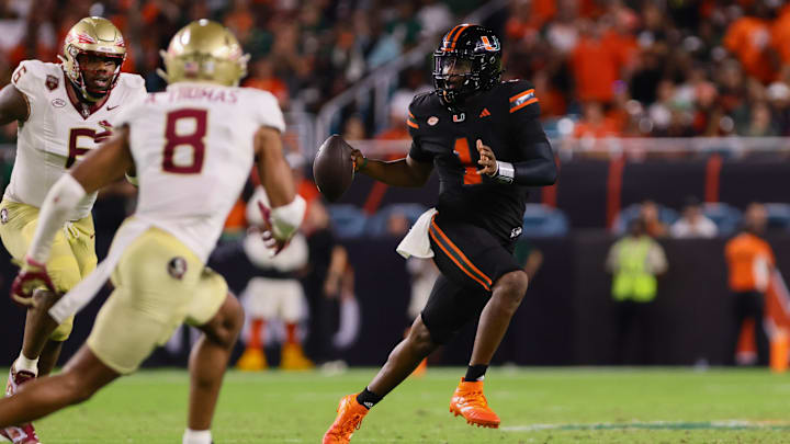 Oct 26, 2024; Miami Gardens, Florida, USA; Miami Hurricanes quarterback Cam Ward (1) runs with the football against the Florida State Seminoles during the third quarter at Hard Rock Stadium. Mandatory Credit: Sam Navarro-Imagn Images