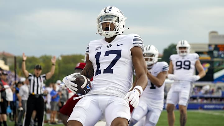 Sep 23, 2023; Lawrence, Kansas, USA; Brigham Young Cougars wide receiver Keelan Marion (17) scores a touchdown during the second half against the Kansas Jayhawks at David Booth Kansas Memorial Stadium. Mandatory Credit: Jay Biggerstaff-Imagn Images Sep 23, 2023; Lawrence, Kansas, USA; Brigham Young Cougars wide receiver Keelan Marion (17) scores a touchdown during the second half against the Kansas Jayhawks at David Booth Kansas Memorial Stadium. Mandatory Credit: Jay Biggerstaff-Imagn Images