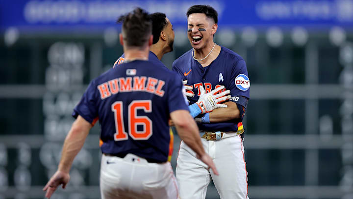 Jun 15, 2025; Houston, Texas, USA; Houston Astros second baseman Mauricio Dubon (14) is congratulated by teammates after hitting a walkoff single against the Minnesota Twins during the tenth inning at Daikin Park.