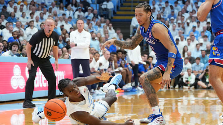 Nov 7, 2025; Chapel Hill, North Carolina, USA;  North Carolina Tar Heels forward Caleb Wilson (8) adn Kansas Jayhawks guard Tre White (3) fight for the ball in the first half at Dean E. Smith Center. Mandatory Credit: Bob Donnan-Imagn Images