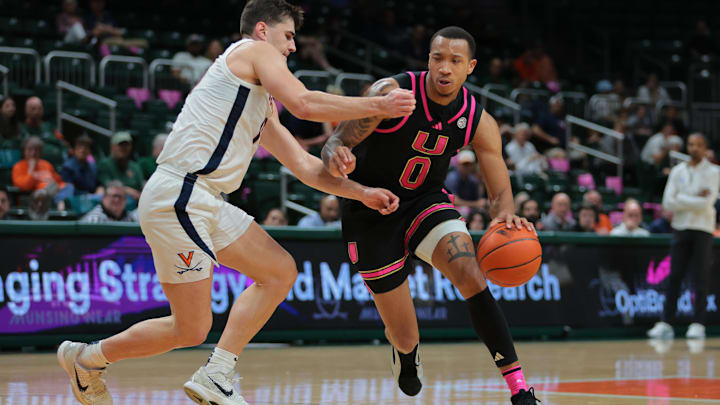 Jan 29, 2025; Coral Gables, Florida, USA; Miami Hurricanes guard Matthew Cleveland (0) drives to the basket against past Virginia Cavaliers guard Taine Murray (10) during the second half at Watsco Center. Mandatory Credit: Sam Navarro-Imagn Images